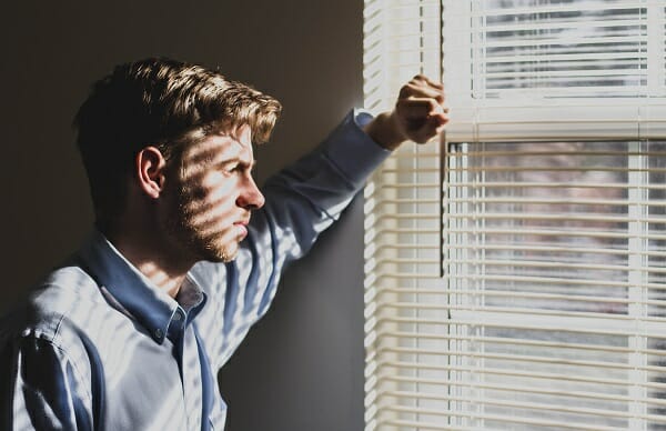 Man Looking Out Window | Telling Somone About Your Addiction | Synergy Recovery Services | Addiction Recovery Treatment | Bakersfield CA