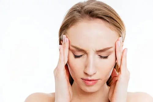 Closeup of a young woman with a headache