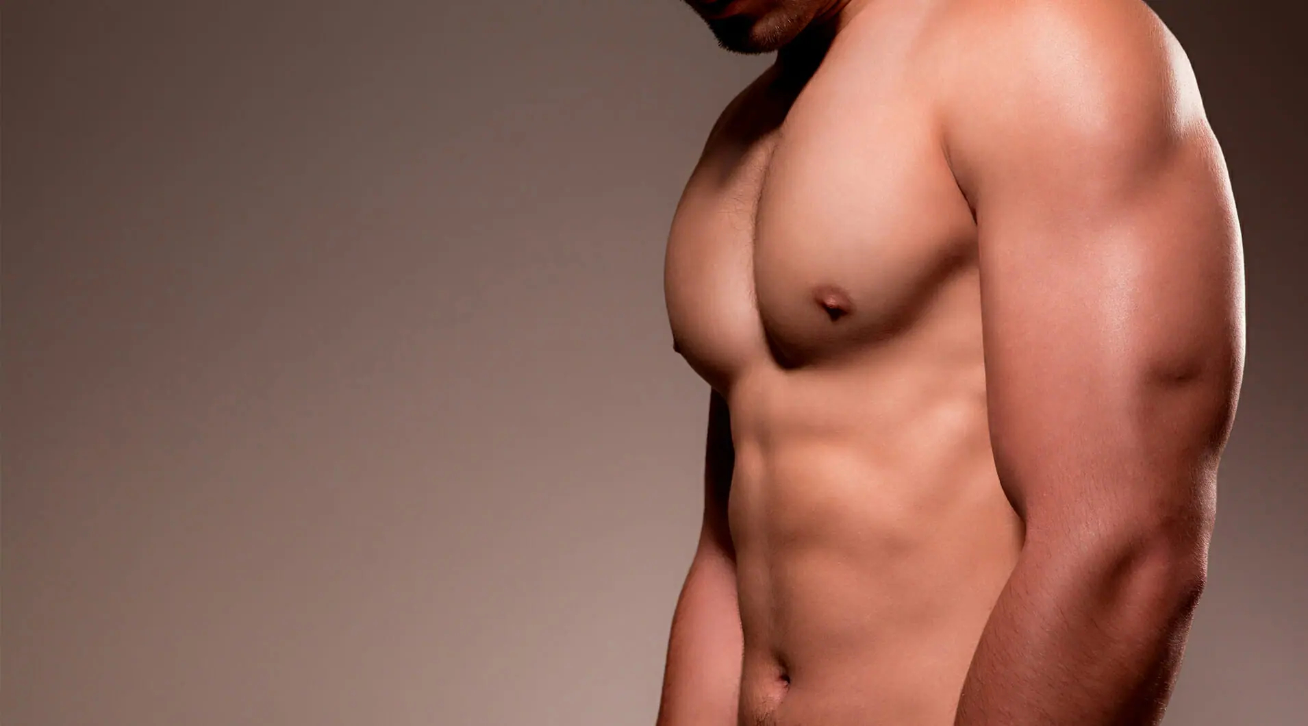 a shirtless man 's chest and arm are shown