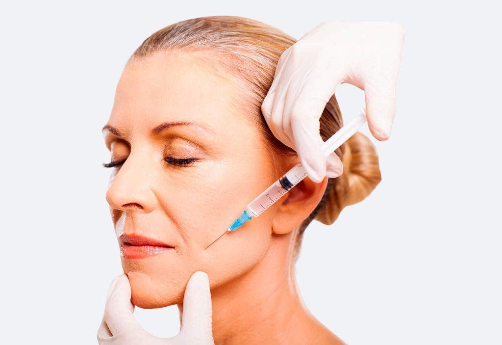a woman is getting a botox injection in her face