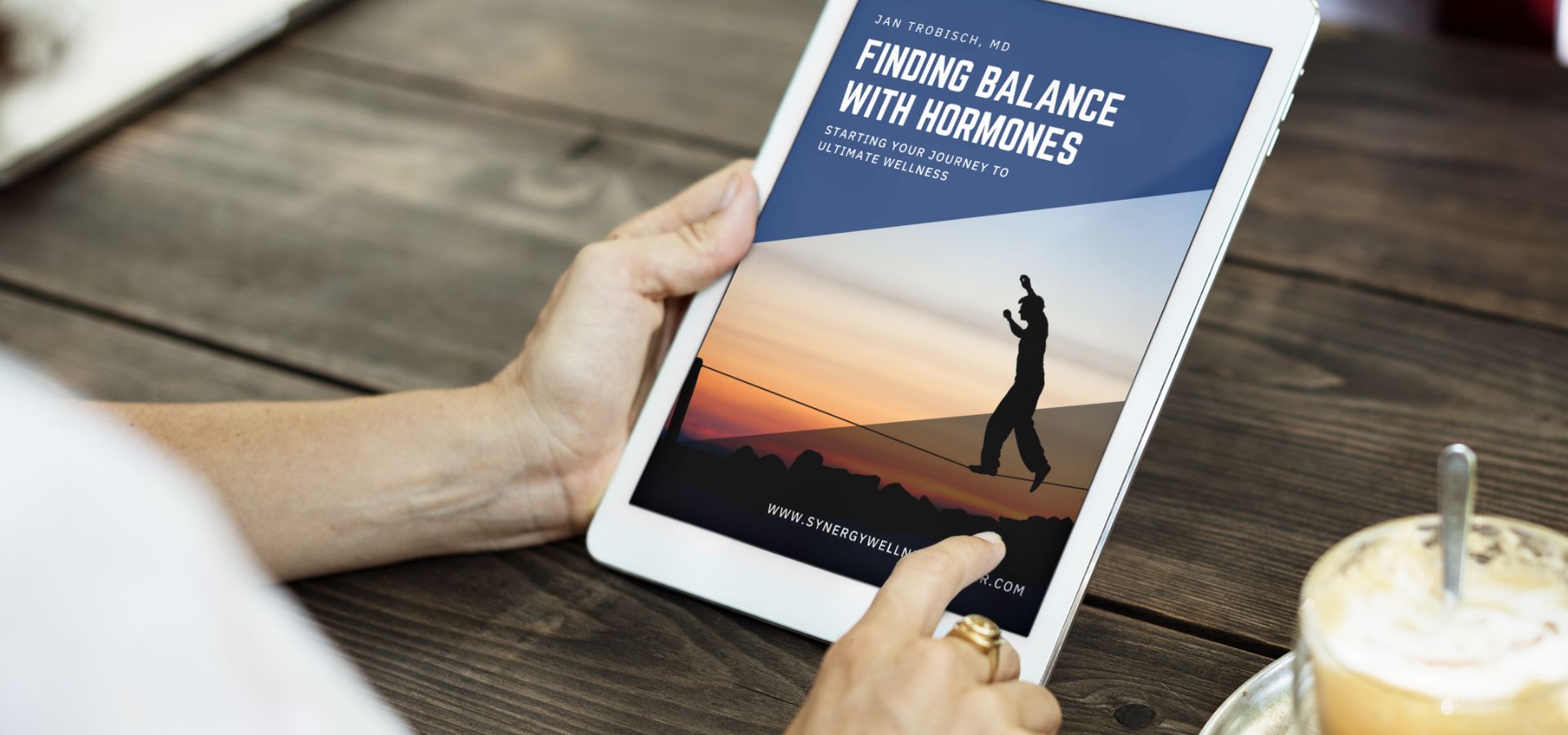 a person is holding a tablet that says finding balance with hormones