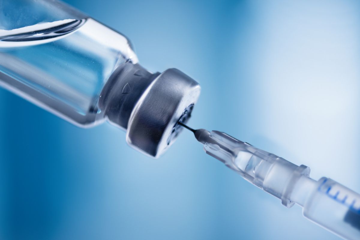 Syringe poking into bottle of semaglutide